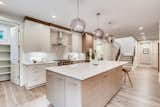 Spacious kitchen beautifully and thoughtfully designed. The kitchen features gourmet appliances, orbed glass-blown lights over the large island, and plenty of storage. 