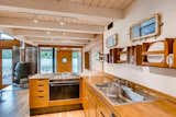 Kitchen, Cooktops, Granite Counter, Light Hardwood Floor, Wood Counter, Track Lighting, and Drop In Sink  Photo 9 of 18 in Portland Float Home by Virtuance Real Estate Photography