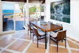 Dining Room, Light Hardwood Floor, Travertine Floor, Table, and Chair Dining Area with Deck Access  Photo 6 of 22 in Sea Spray La Jolla by Drew & Tim Nelson
