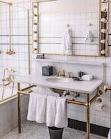 The Ludlow Hotel white bathroom with gold finish brass accents.