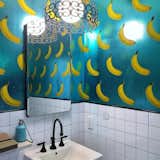 Media Noche bathroom with banana pattern wallpaper.
