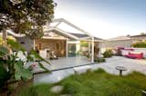 The beach cottage opens up to the garden.