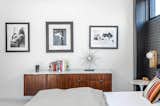 The bedroom is decorated with black-and-white beauty and mid-century furnishings.