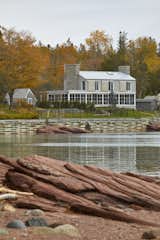 Exterior, Stone Siding Material, House Building Type, Metal Roof Material, Wood Siding Material, and Gable RoofLine View from across the inlet  Photo 13 of 13 in Bay of Fundy house by Paul French