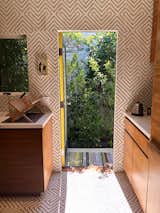 Cement tile spills out to side patio. Accent yellow pops through door trim.