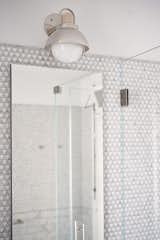 Close-up of grey + white tiles and brushed silver lighting fixture in Park Slope bathroom, by JMorris Design.