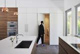 Hidden door in the cabinetry conceals the laundry room.