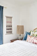 Classic white walls create the perfect backdrop for funky, bright, and patterned pillows and accents.