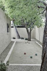 A bocce ball court rests on the side of the house for some hidden fun.