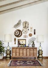 Living Room, Table Lighting, and Terra-cotta Tile Floor Oversized vintage lamps flank a gorgeous wooden console atop with a mis-matched art wall.   Photo 5 of 20 in Desert Glam by Colossus Mfg.