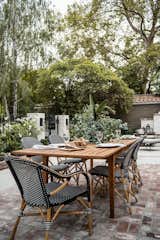 Natural wood paired with black and white accent chairs from Article come together for a dining table that seats up to ten. The perfect setting for your next dinner party, or back yard bbq.