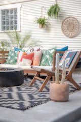 A colorful and bright backyard oasis for lounging and cozying up by the fire.