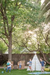 Outdoor, Back Yard, Trees, Wood Fences, Wall, Vertical Fences, Wall, Shrubs, and Grass A backyard isn't complete without a patterned teepee for reading and adventures!  Photo 6 of 8 in East Sacramento Backyard by Colossus Mfg.