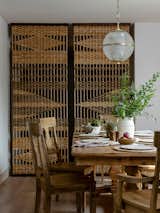Custom built and hand woven screen wall lends privacy to the dining room from the entry way.