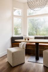 All day nook with custom built grey fabric and burnt orange leather cushions, oval table made by wood worker in Auburn, CA, and oversized iron pendant.