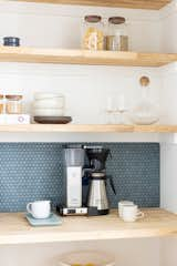 Kitchen, Mosaic Tile Backsplashe, and Wood Counter Blue penny tile pops against a clean white and natural wood pantry with smart plugs.  Photo 11 of 21 in Bright Harmony by Colossus Mfg.