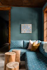 Cabin loft with custom Room & Board pull out sofa, Farrow & Ball blue walls, and reclaimed wood stumps.