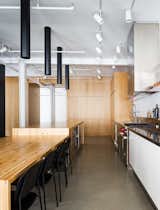 The minimalist and spacious shower is in white ceramic 2x2. The faucets are from Fantini. The shower is open to the bedroom with a simple glass partition.  Minimalist bathroom with countertop and molded monobloc sink in white Corian.