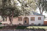 A quaint white stucco home in Denver, CO. 