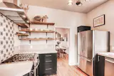 Beautiful kitchen in Denver, CO with open shelving and updated appliances. 