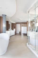 Master Bath has mosaic tiles curved vanity area, ceiling hung custom lighted mirrors  and shinnoki oak panels 