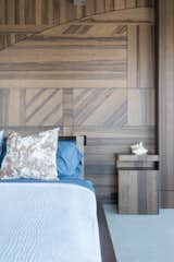 Master Bedroom with shinnoki wood panels in geometric patterns and custom bed that spins to see the ocean view