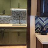 Kitchen, Colorful Cabinet, Wood Cabinet, Medium Hardwood Floor, Ceramic Tile Backsplashe, Subway Tile Backsplashe, Undermount Sink, Accent Lighting, and Quartzite Counter A playful mix of patterns with pops of color as you move from the kitchen to butler's pantry.    Photo 1 of 1 in Galena Forest, NV by Solanna Design & Development