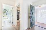 Private entry hidden by a hand-toweled archway reminiscent of the great Spanish Colonial Revival architecture