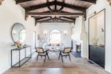 The vaulted ceiling draws attention to impeccably restored hand painted cedar beams from the original house, once an exhibition property for Southern California’s Pacific Ready-Cut homes