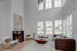 Living Room, Sofa, Light Hardwood Floor, and Standard Layout Fireplace Spacious living room features 10' ceilings and an abundance of natural light  Photo 2 of 15 in Pinewood Forest Anders Cottage by Emily