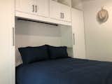 The upstairs loft is large enough for a queen bed and is surrounded by built in storage. The shelves include connections to charge your phone and other personal devices.  