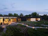 Main house, looking at north wing, with exterior lights accenting siding