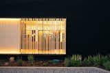 Main house, detail of exterior lighting accenting sunscreen slats and siding