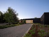 Approach to front entry, exterior lights accenting siding  