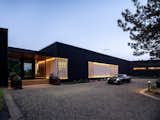 Front entry with exterior lights highlighting slats and siding