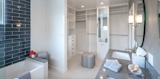 Refurbishment full space planning interior architecture Master bath en suite includes a custom master closet wallpaper and bespoke vanity beautiful polish nickel fixtures.