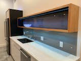 Kitchen detail with acrylic backsplash, custom box shelf