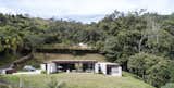 Exterior, Stone Siding Material, House Building Type, Metal Roof Material, and Flat RoofLine Fachada  Photo 13 of 30 in Entremuros House by BASSICO ARQUITECTOS