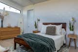 Primary Suite Bedroom with Aerin Clemente sconces and  iridescent  jelly fish accent wall. 