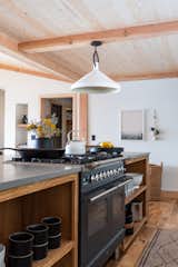 Kitchen, Quartzite Counter, Open Cabinet, Medium Hardwood Floor, Pendant Lighting, and Range Ilve kitchen range and open shelving  Photo 3 of 38 in Sweetwater Cottage by PLACE INTERIORS