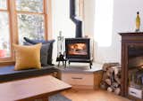 cozy Jotul wood stove on a custom built raised hearth