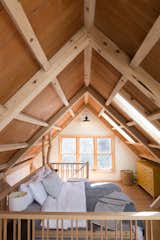 Bedroom, Lamps, Dresser, Bed, Wall Lighting, Dark Hardwood Floor, and Accent Lighting Timberframed loft  Photos from Shack Up Cabin