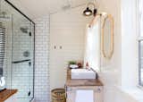 Bath Room, Wall Lighting, Light Hardwood Floor, Pedestal Sink, Full Shower, Subway Tile Wall, Ceiling Lighting, Wood Counter, One Piece Toilet, and Enclosed Shower  Photo 7 of 19 in Shack Up Cabin by Paula Washington