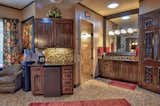Large vanity mirrors give an "infinity" view to a warm, inviting bathroom which boasts his and hers toe-heaters on timers below both vanity cabinets.