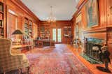 Mahogany-paneled library includes one of seven fireplaces in the home.