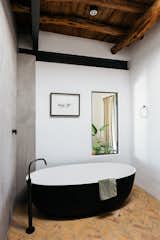 Bath Room, Freestanding Tub, Ceiling Lighting, Stone Slab Wall, Open Shower, and Ceramic Tile Floor  Photo 9 of 20 in The Ibiza Campo Loft by Jurjen van Hulzen