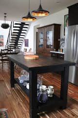 The kitchen island, from Restoration Hardware, and the pendants, designed by Tom Dixon, work so well in our space.