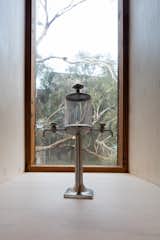 Narrow windows to the rear frame landscape beyond and celebrate the much prized absinthe dispenser. The slot windows to the south capture sea breezes in summer as natural cooling device 