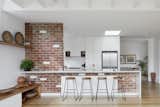 Existing brick wall is reinstated with recycled brick and opened to form connection between kitchen and  living 