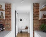Texture of existing brick to the kitchen and v-grooved timber lining to the entry provide warmth with fresh white maximises light throughout. 